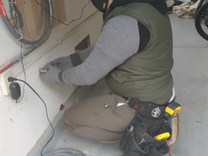 Electrician performing outlet wiring in a South Strabane garage