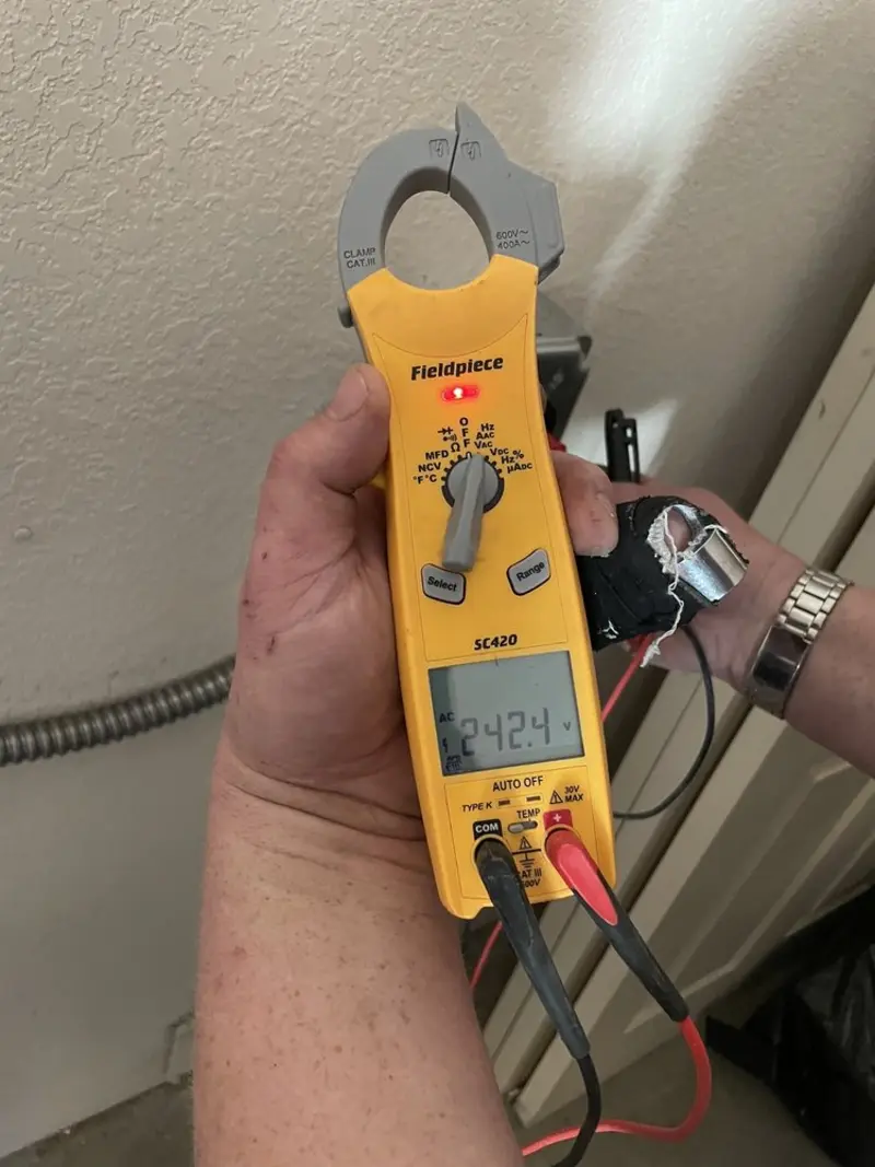 Voltage testing with clamp meter during Recessed Lighting Installation in South Strabane